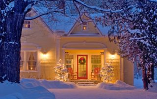 A house decorated for Christmas with snow.