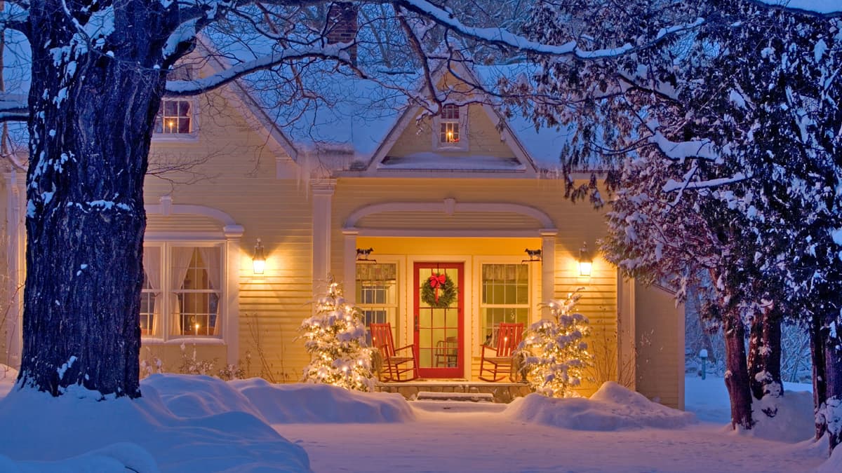 A house decorated for Christmas with snow.